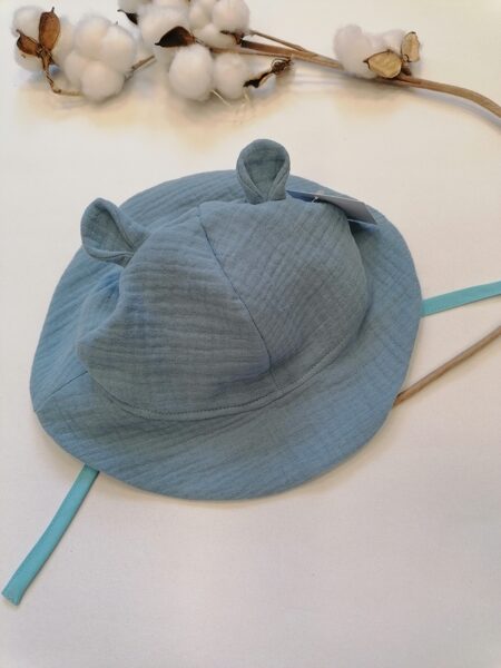 Zila muslīna auduma cepure ar saitēm. 